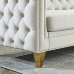 close up handcrafted copper nailhead trim on low profile rolled arms of chesterfield velvet sofa
