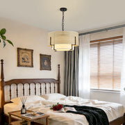 Aura 19.7 inch hand woven rattan pendant light fixture with matte black iron chain suspension on white background.