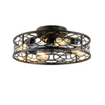 Front perspective of an illuminated 20 inch matte black caged ceiling fan with four glowing amber vintage bulbs inside an interlocking circles iron frame